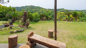 A wooden seesaw in a garden with trees and rocks. - Sasayakana Ouchi Fuuki (Futtsu)