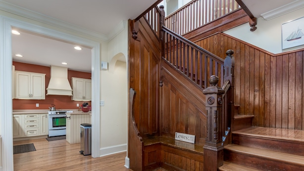 A wooden staircase with a sign indicating 'Lewes' on the landing. - 311 E Market - Two blocks to Lewes Beach! (Lewes)