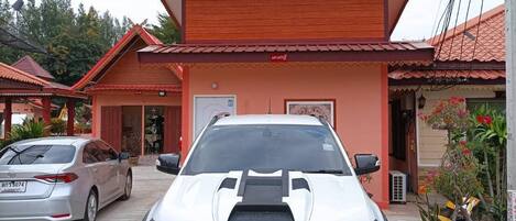 A white Ford Ranger parked in front of a building with a red roof and a sign that reads "RANGER".