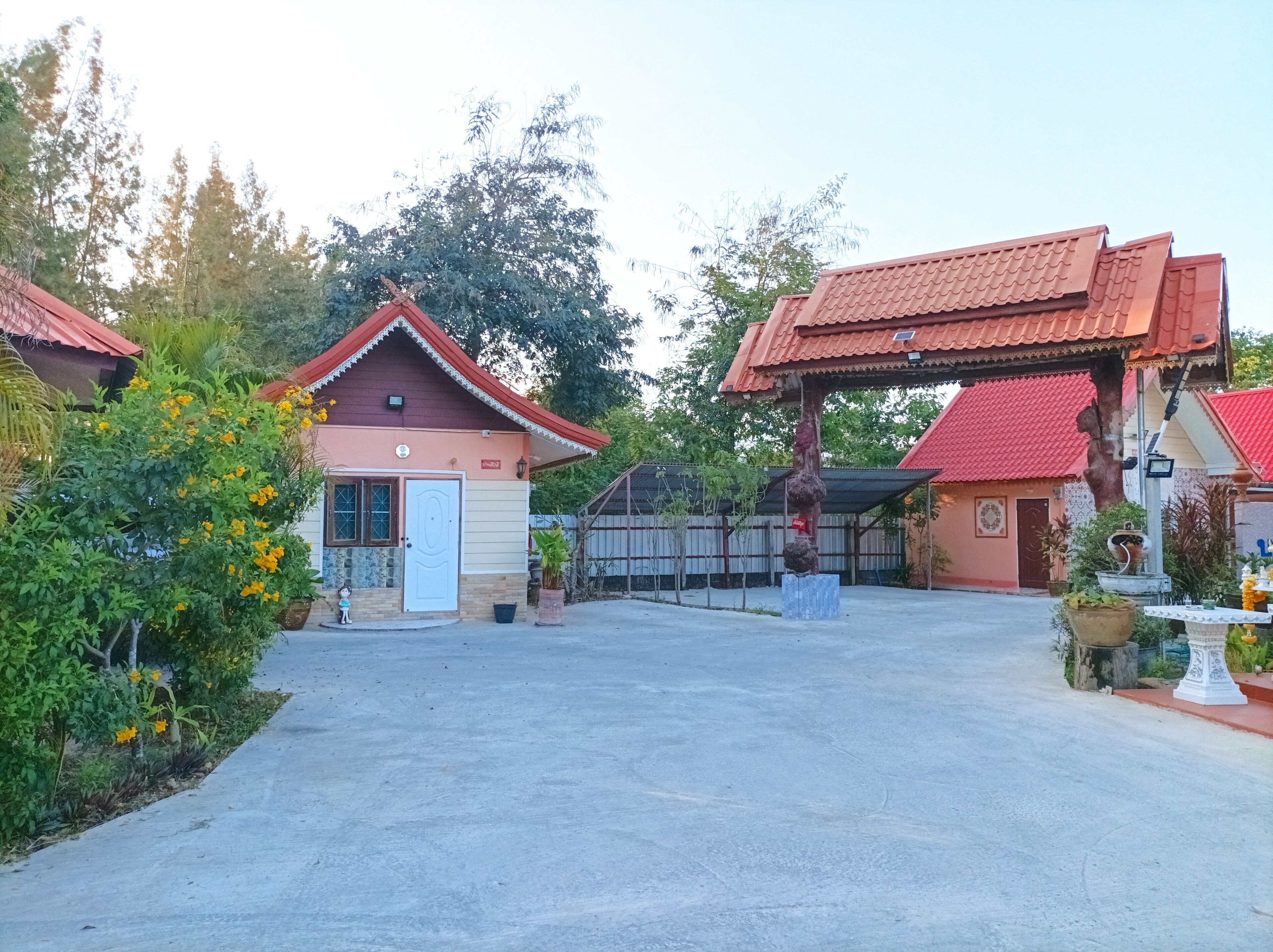 A traditional building with a red roof, a small porch, and a white door.