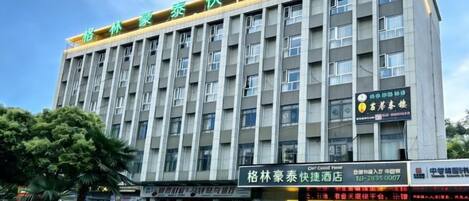 A multi-story hotel with a prominent sign at the top.