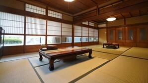 A traditional Japanese room with tatami flooring, a low wooden table, and sliding doors. - Uji Tea Inn (Uji)
