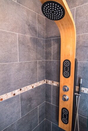Bathtub, hair dryer, towels, toilet paper