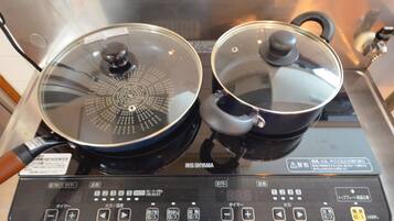 An electric stove with two pots on it.