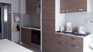 Una cocina moderna con armarios de madera, lavavajillas integrado y una cafetera sobre la encimera.