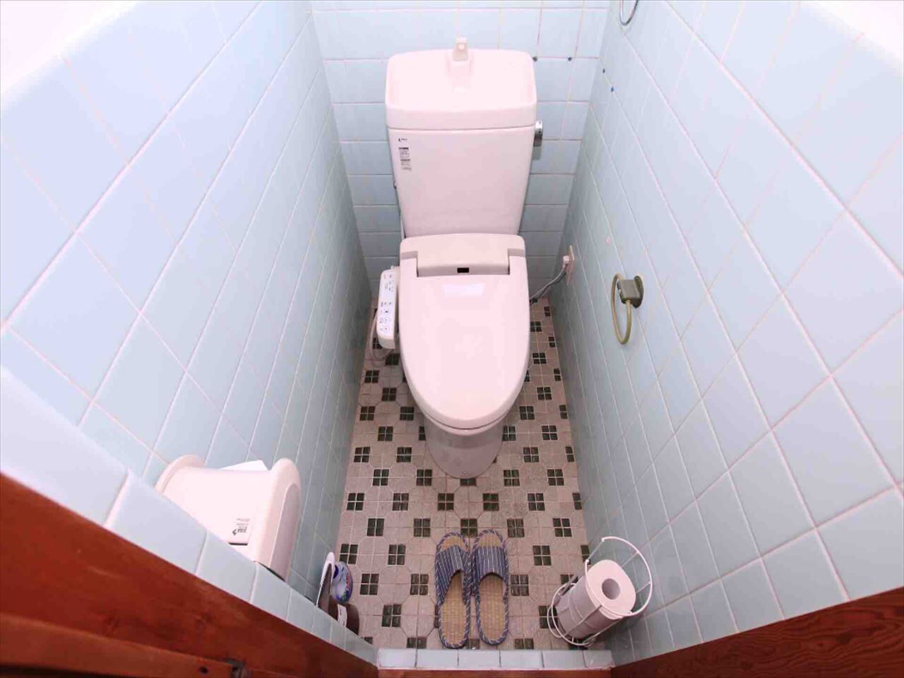 A small bathroom with a toilet, a sink, and a shower area.