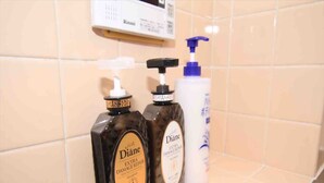 A bathroom shelf with two bottles of Diane hair care products and a bottle of hand soap. - Goraku Shinfukae (Osaka)
