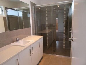 Shower, hair dryer, soap, toilet paper