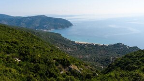 Eine Küstenlandschaft mit Blick auf das Meer und Hügel.
