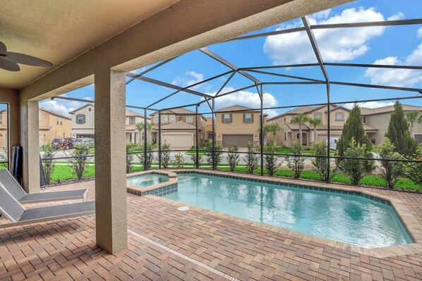 A covered outdoor swimming pool with a view of residential buildings.