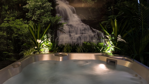 A hot tub with a waterfall backdrop, surrounded by lush greenery. - La Villa Resort (Pieve a Nievole)