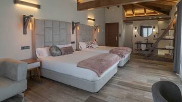 A spacious bedroom with a large bed, bedside tables, and a built-in bench.