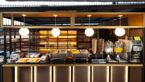 A buffet setup with various food items and a coffee machine. - Hotel MX mas centro CDMX, Trademark Collection by Wyndham (Mexico City)