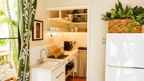 A compact kitchen with a sink, a coffee maker, and a refrigerator. - An Affordable Alternative to Expensive Accommodations in Poipu (Poipu)