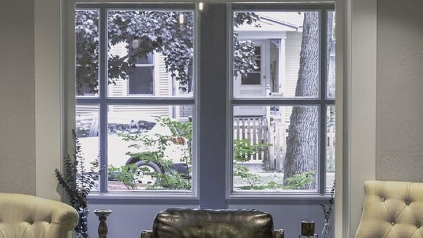 A room with a large stained glass window, two leather armchairs, and a wooden coffee table. - Historic Neighborhood 2 Blocks from Downtown Bozeman. (Bozeman)