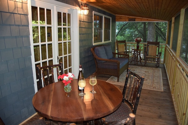 Screened porch for dining and relaxing. Great view of the shoals of Cane Creek.