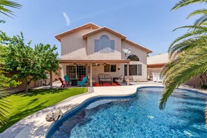 A house with a swimming pool, a patio with chairs, and a satellite dish. - Relax in Style! Private Pool, Resort Backyard & 4BR Luxury Oasis in Chandler (Chandler)