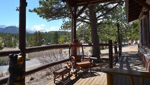 A wooden deck with a view of mountains and trees. - Close to Downtown Estes Park, RMNP, Hot Tub, Activity Shed! Far View Cabin (Estes Park)
