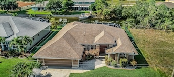 Snowbird-friendly home with lanai, private pool, & canal access