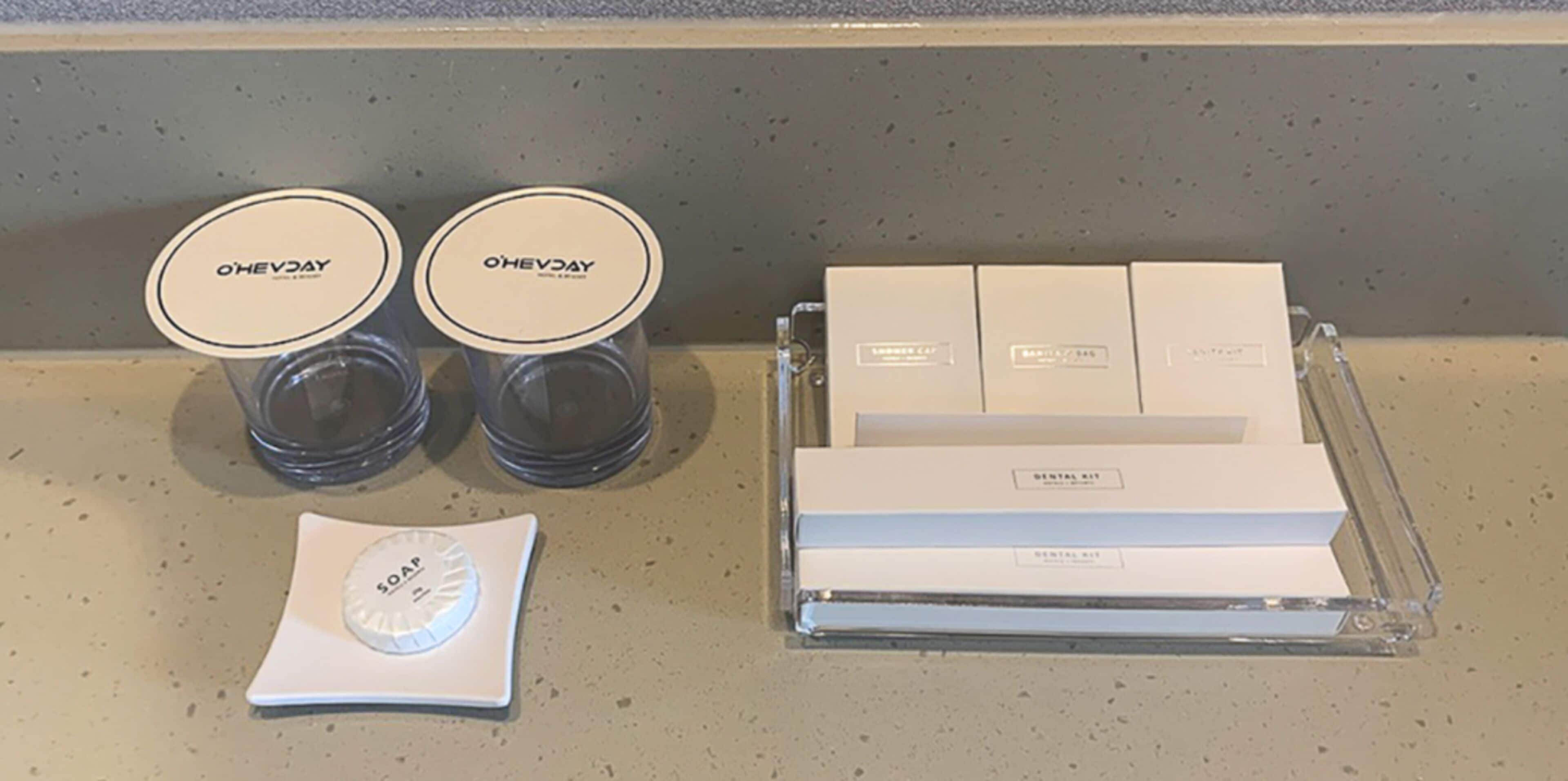 A dental care kit with two jars of O'Hevday soap and a soap dispenser on a countertop.