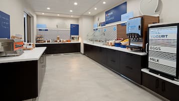 A modern breakfast area with a digital menu display, a coffee machine, and a yogurt dispenser.