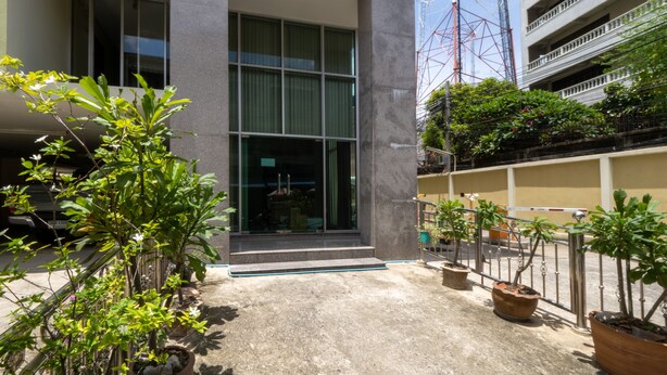 A modern building with large windows and a concrete entrance.