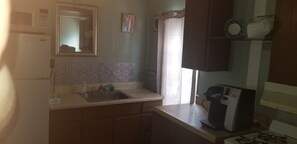 Fridge, microwave, stovetop, coffee/tea maker