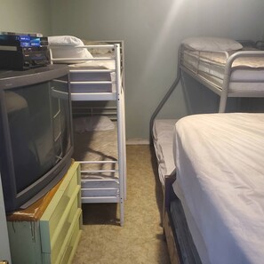 A bunk bed room with a television on a stand. - Rustic1BRPet&420 Friendly2.5blocksToBoardsSeptSpecialsProm&SeniorWks22Under25ok (Wildwood)