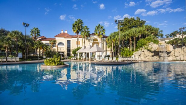 A resort with a large pool, palm trees, and a building with a red roof. -   $899/OBO, 2 Br/2Ba for 8, Balc, Kit (Orlando)