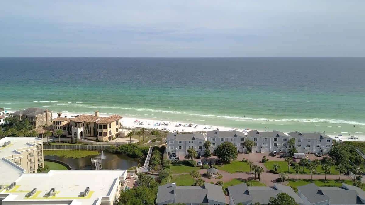 A coastal hotel with beachfront rooms, a swimming pool, and a view of the ocean.