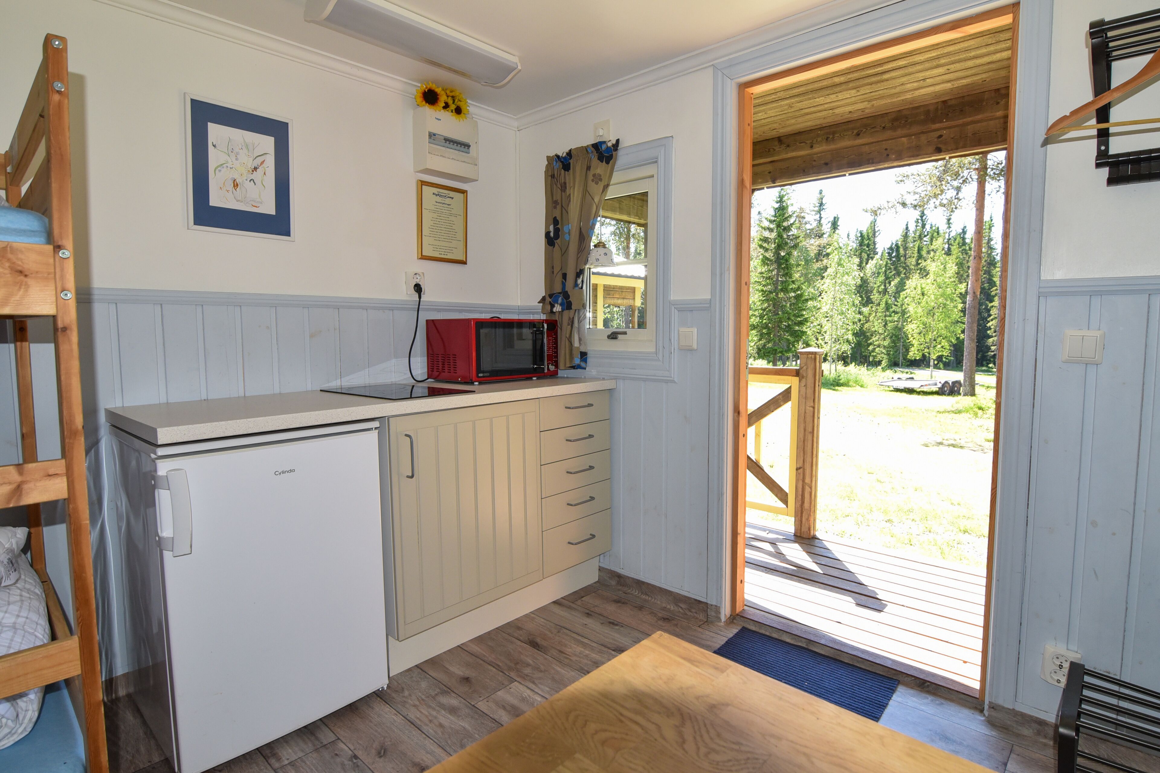 basic cabin, shared bathroom | living area | led tv