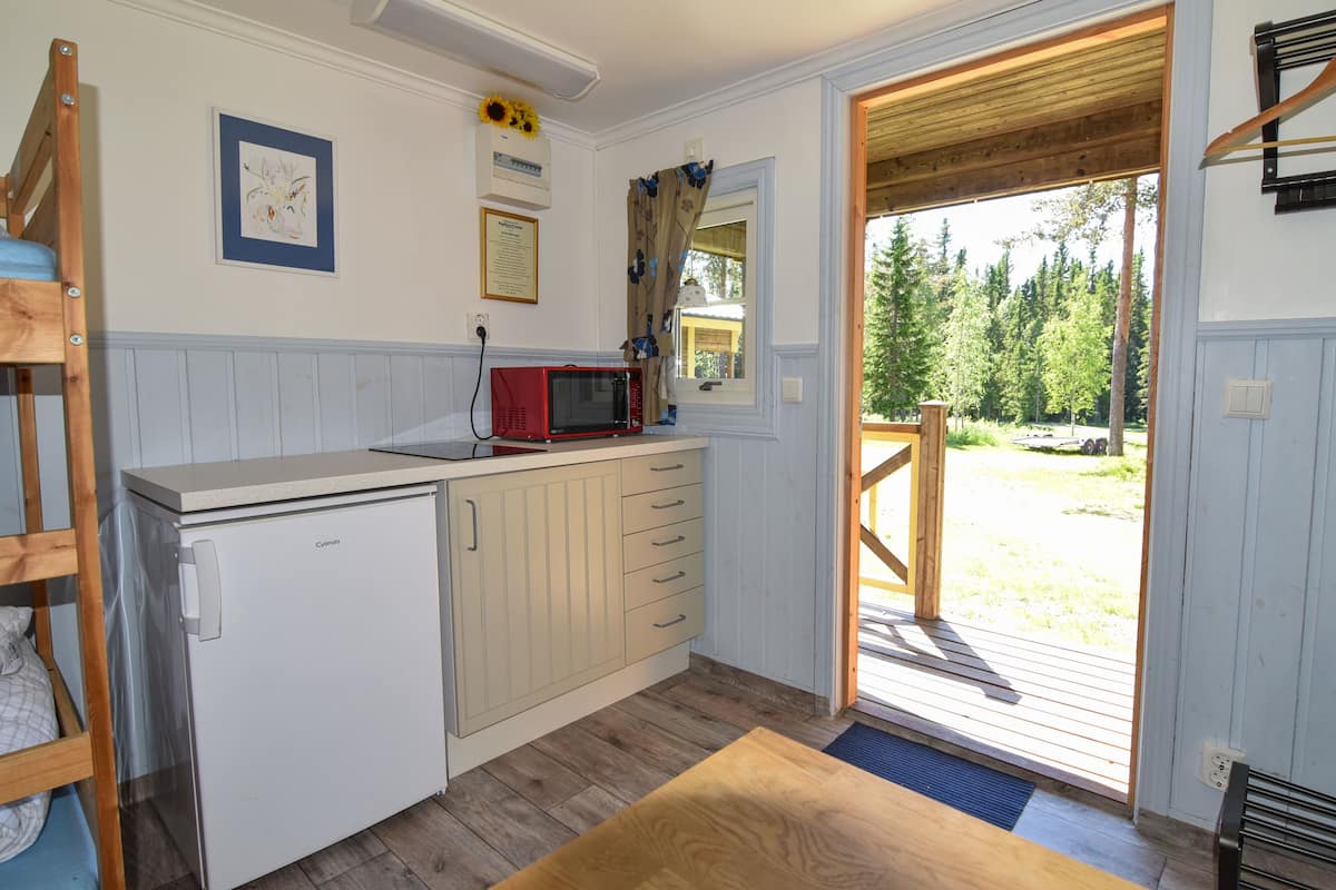 basic cabin, shared bathroom | living area | led tv