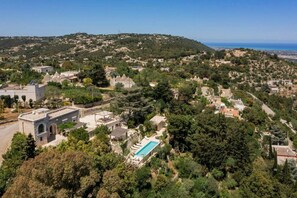 An aerial view of a residential area with houses, a swimming pool, and a hilly landscape in the background. - Villa Lemorè - Luxury villa in Puglia with seaview and private pool (Fasano)