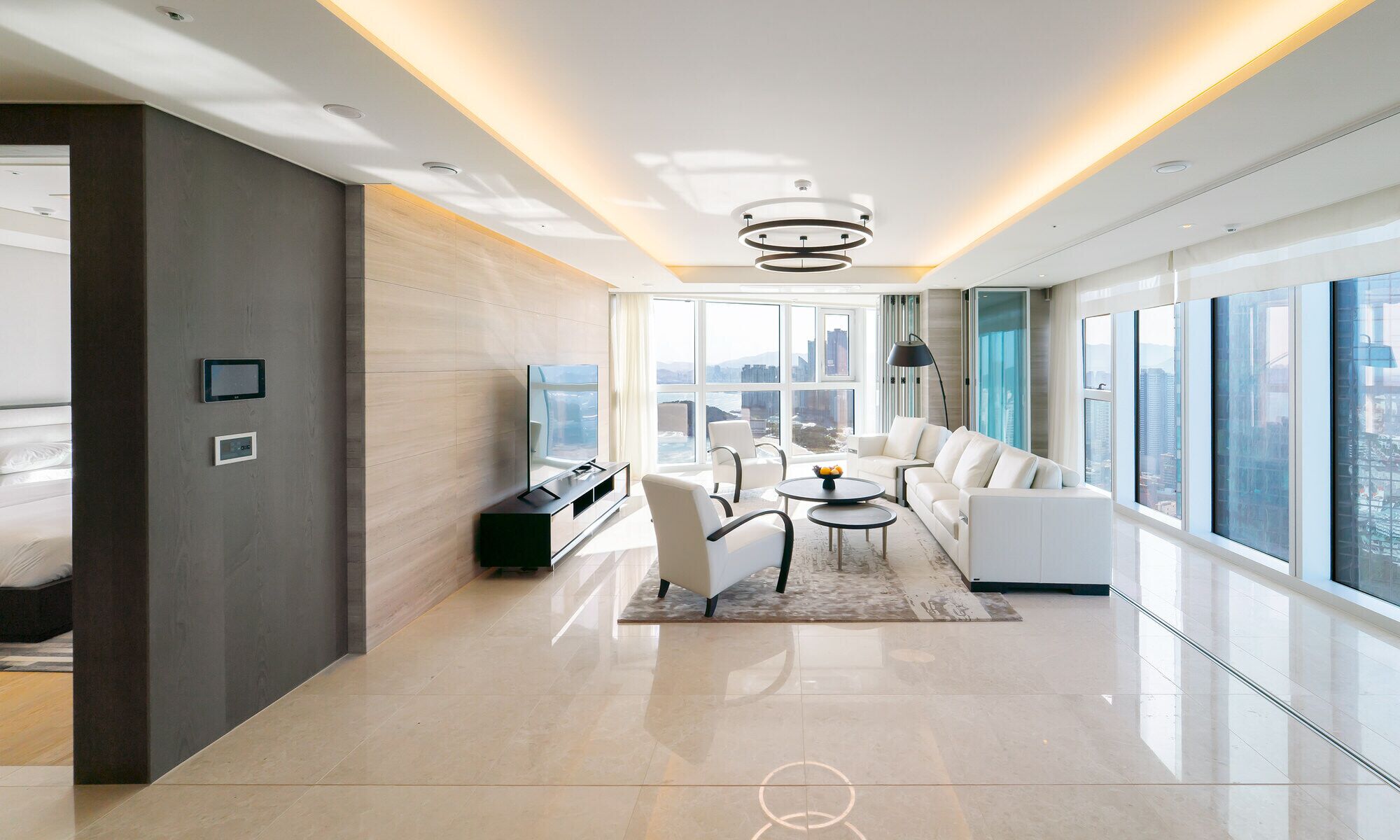 A modern living room with a sofa set, a coffee table, and a TV.
