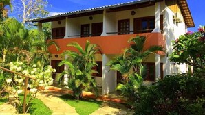 A two-story building with a garden pathway leading to the entrance.