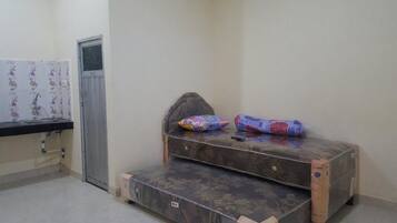 A small room with a bed, a window, and a sink.