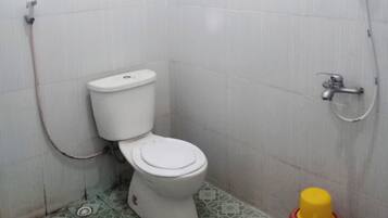 Ein kleines Badezimmer mit Toilette, Dusche und Waschbecken.