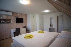 A bedroom with two beds, a desk, a chair, a TV, and a wardrobe. - Villa Lika Annex (Plitvicka Jezera)