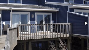 A two-story building with a balcony and a deck. - Oceanfront Escape at Eastern Sails (North Topsail Beach)