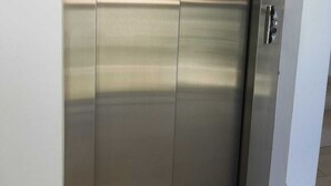 A metallic elevator door with a handle, set in a building. - Sea House Rimini Fiera (Rimini)