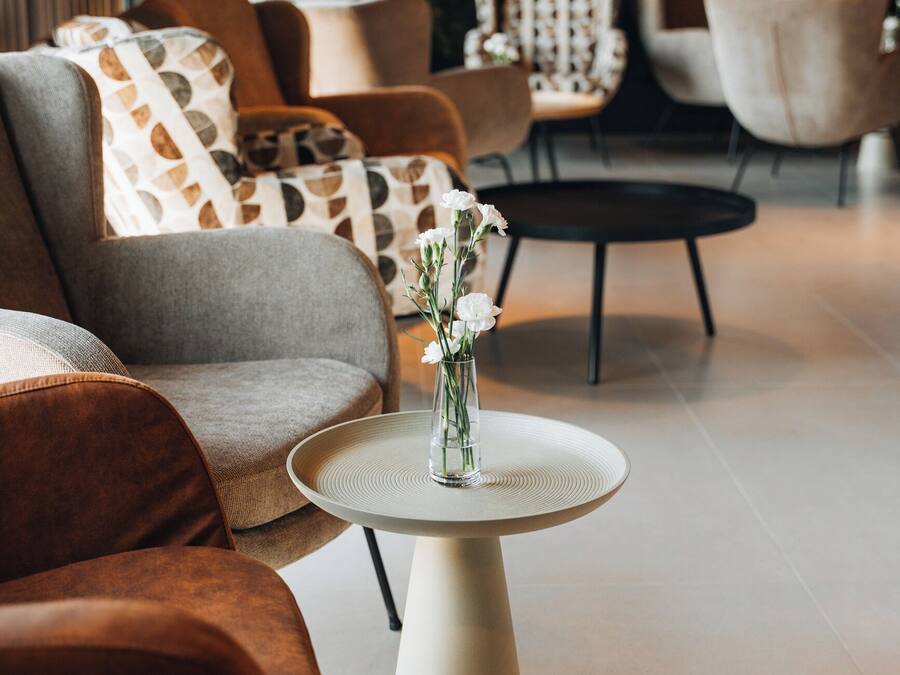 A modern living room with a sofa, armchairs, and a coffee table.