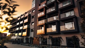 A modern multi-story building with balconies and large windows, likely a hotel or residential complex. - ZatorHome apartamenty (Zator)