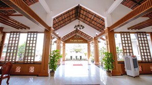 A spacious lobby with a high ceiling, wooden beams, and large windows. - Thien An Hotel (Can Tho)
