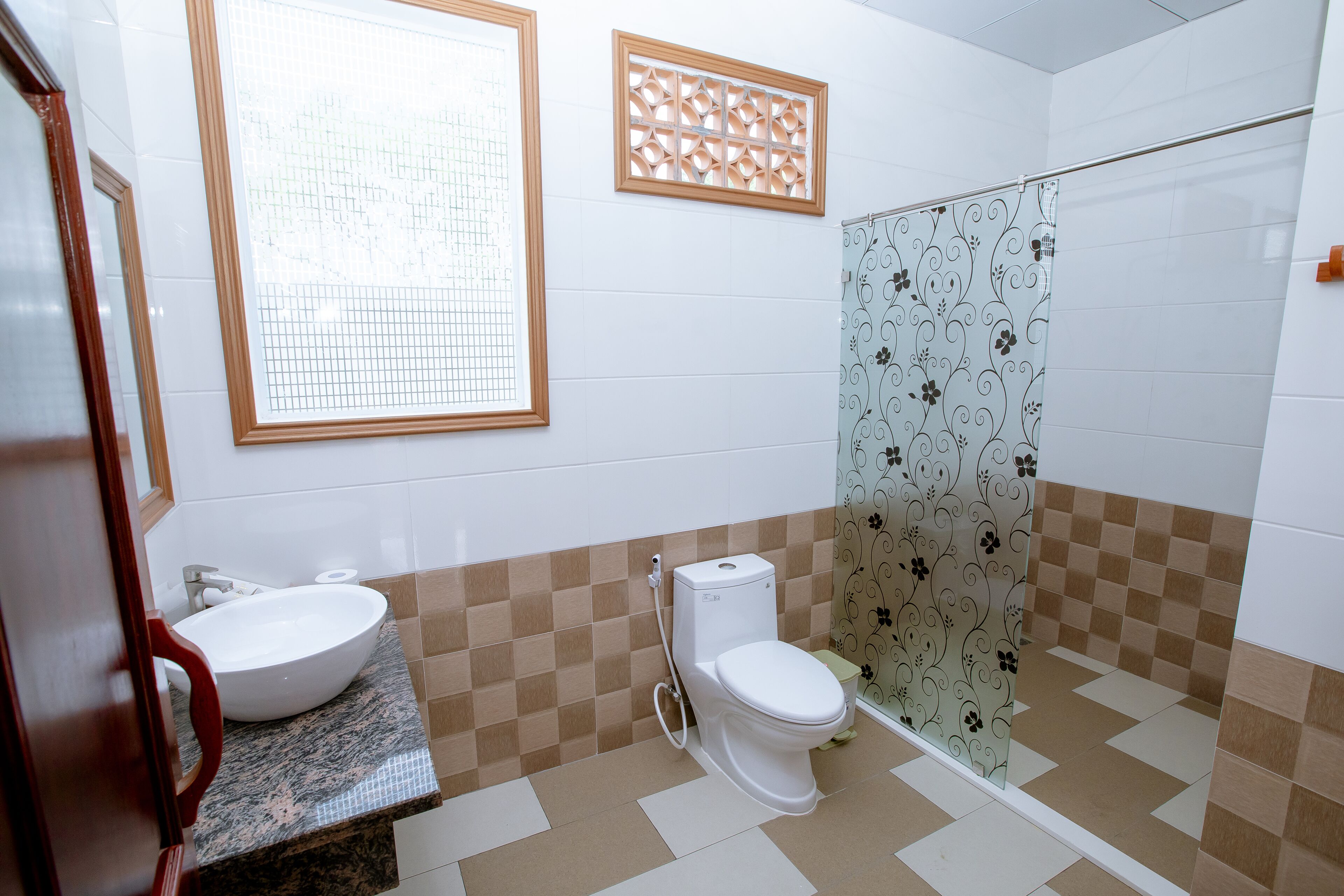 A bathroom with a sink, toilet, and shower.
