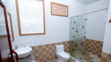 A bathroom with a sink, toilet, and shower.