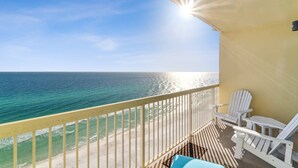 A balcony with a view of the ocean, white Adirondack chairs, and a yellow railing. - Celadon Beach Resort by Book That Condo (Panama City Beach)