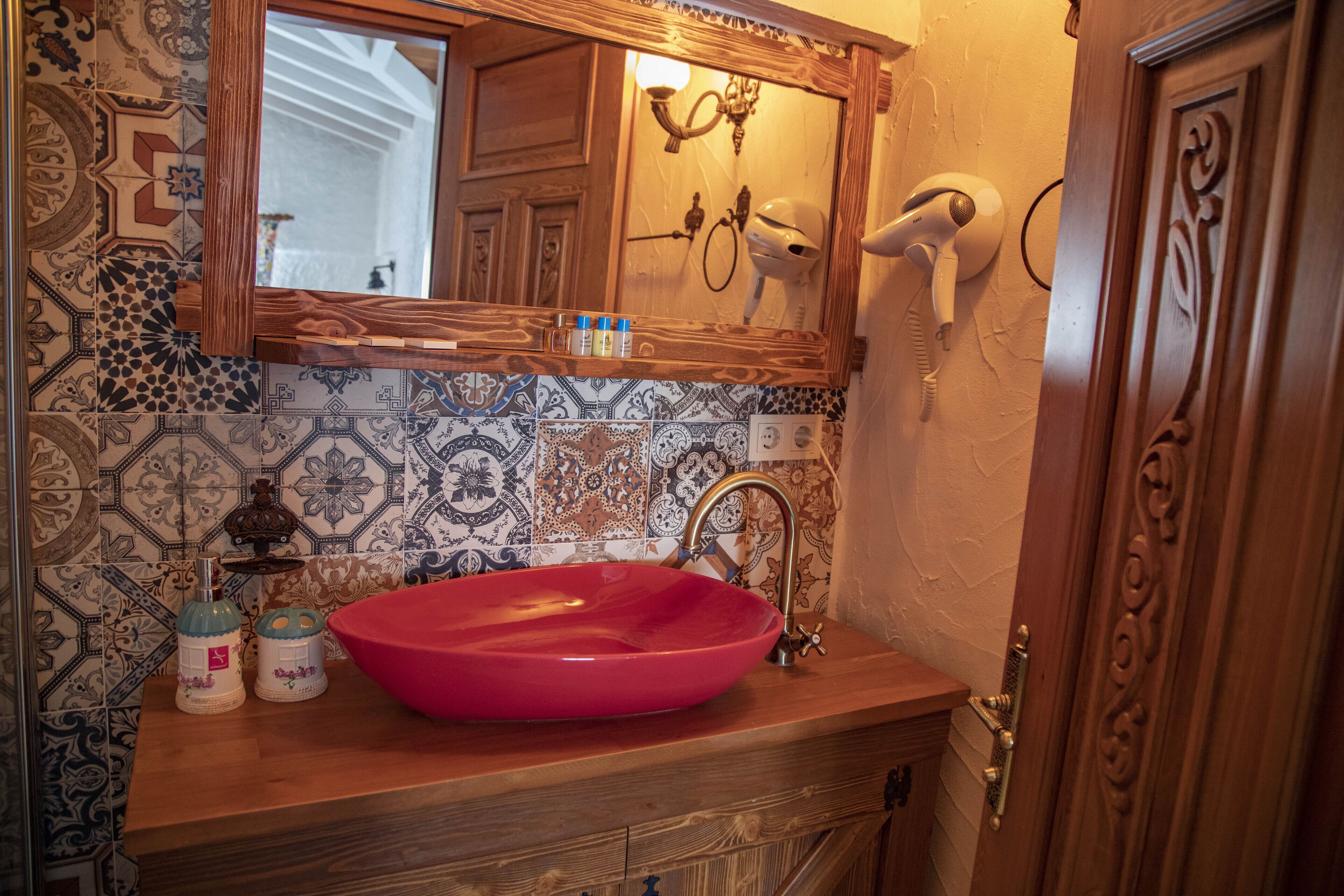 deluxe room | bathroom | shower, rainfall showerhead, hair dryer, slippers