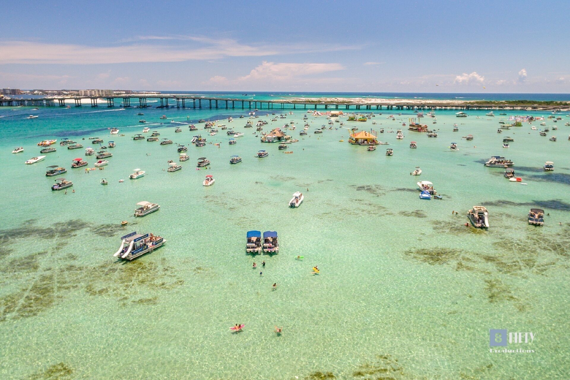 A marina with numerous boats and a pier extending into the water.
