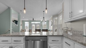 A modern kitchen with white cabinetry, stainless steel appliances, and a granite countertop. - 30A 5 Minute Walk to Beach / Private Heated Pool / View / Family Vacation (Santa Rosa Beach)