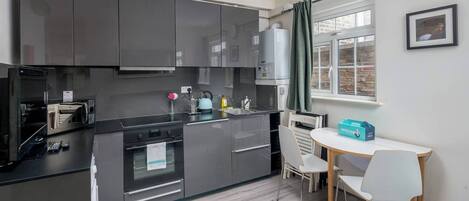 Microwave, oven, cookware/dishes/utensils, dining tables